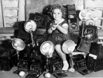 Shirley Temple with her trophies from all the paparazzi she killed