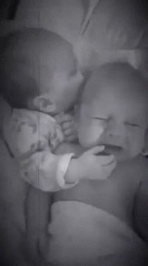 Sister soothes her twin  weeks old brother