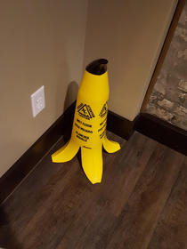 Slippery when wet sign shaped like a banana peel