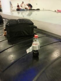 Someone just couldt let his coke go to waste at check-in