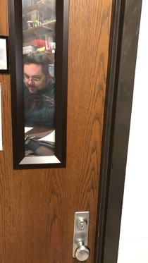 Teacher put up a picture of himself on his door so it looks like hes always in his office