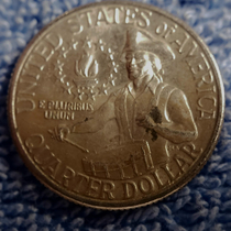 The dirt on this coin makes it look like hes carrying a frog with him