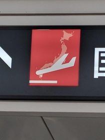The outline of Japan on the sign makes it look like the plane is crashing in a ball of flames