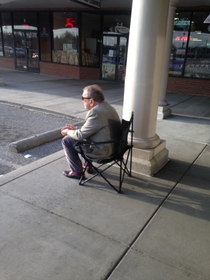 They removed the bench from in front of the Liquor store so this guy brings his own seat