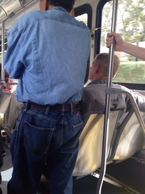 this asshole on the bus wouldnt let this guy sit down so he stood as close to him as he could