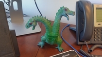 This cheap plastic dragon has always sat front and center on every professional desk I have ever occupied Strangely nobody has ever asked about it Ever
