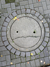 This sad manhole cover