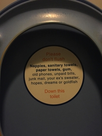 This sticker on the underside of a train toilet seat