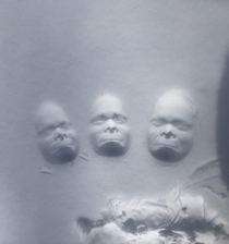 Tried to make a cute imprint in the last of the fresh snow - instead made  scary monkey heads