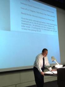 University professor reading his own teaching reviews to the class