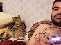 Yes I have a hairy chest but thats not what is important here look at how me and my cat chill while I play videogames