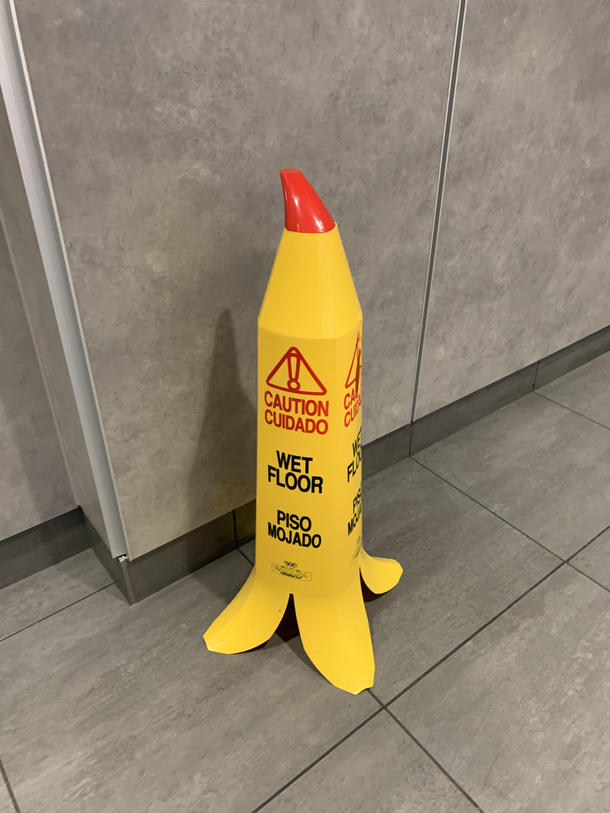 A banana shaped wet floor sign at CVG airport