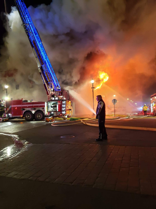 A coworker of mine snapped a picture during a fire standby and accidentally caught her parter trying to douse the flames himself