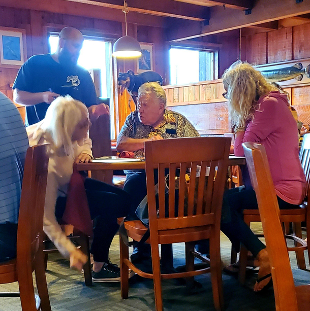 A dog taking his human out for a nice meal