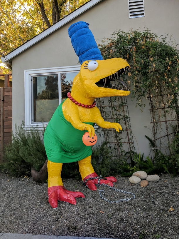 A house in our city always dresses up their dino statue for Halloween This year takes the cake