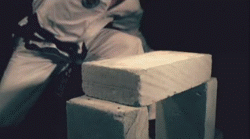 A karate chop to a breeze block in slow motion