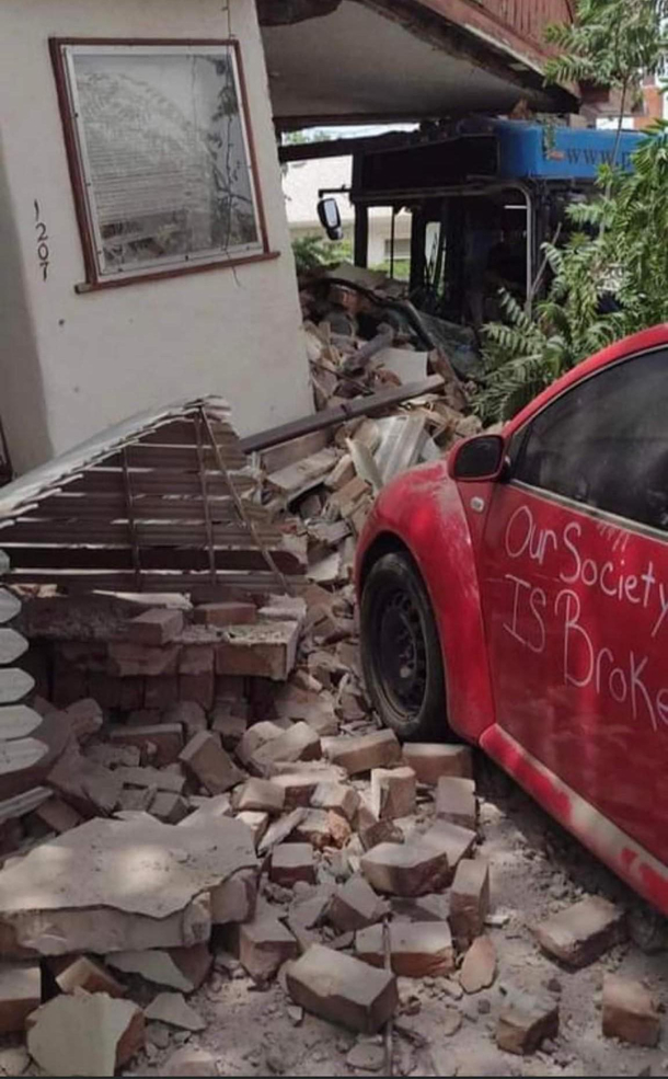 A local city bus crashed into three cars then a house ironically one of the cars it crashed into had an applicable message