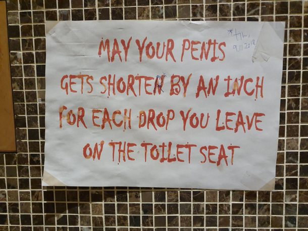 a sign at a restaurants toilet