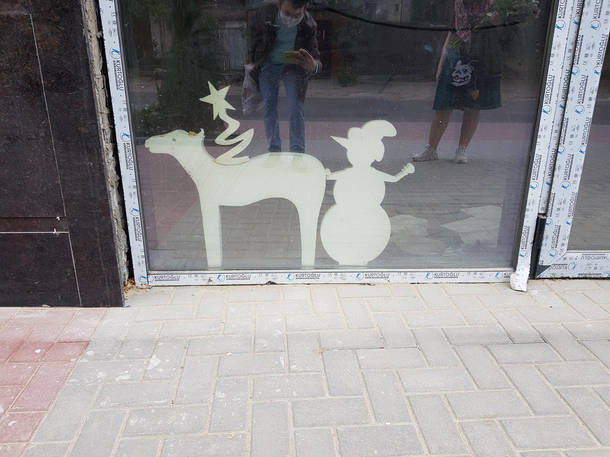 A snowman with naughty hands