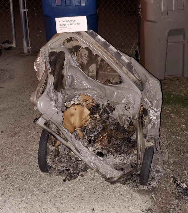 A trashy house in our otherwise nice neighborhood filled their trashcan with something that melted it It hasnt been moved for several weeks now Someone added an art installation placard to add some humor to it 