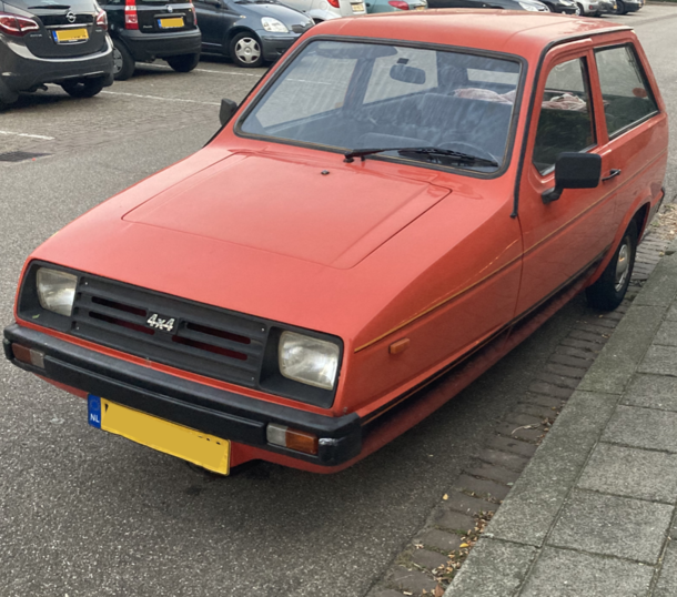 A -wheel car with a x badge