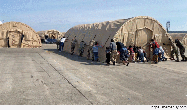 Afghan refugees help Airmen move tents