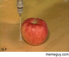 An apple being cut in half using water