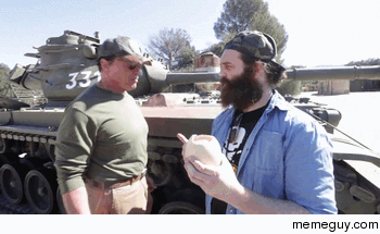 Arnold Schwarzenegger preparing an ostrich egg on a tank
