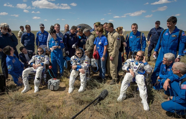 Astronauts who just landed from the ISS look like theyre just chillin in a middle of nowhere with their gang behind them
