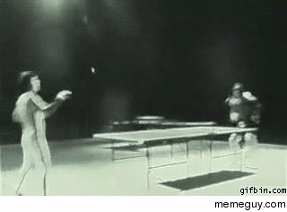 Bruce Lee playing ping pong with nun chucks