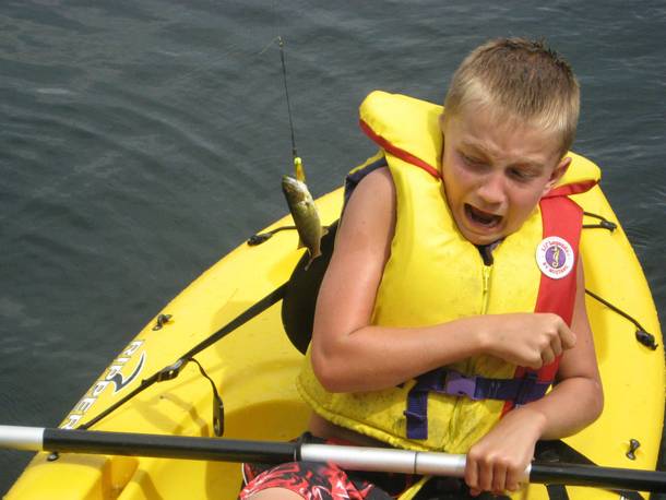 Caught this photo of my younger brother at the best moment with a fish