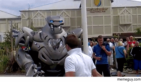 Drunk guy tries to fight a guy in a robot suit Gets punched by robot