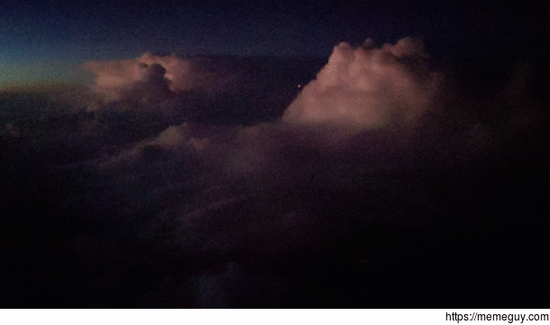 Flew past a big storm with lots of lightning You can see another plane blinking dwarfed by the clouds