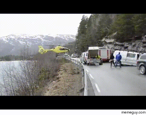 Helicopter balances on road railing
