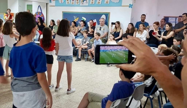 His son graduates from st gradebut shhhh there is a game now