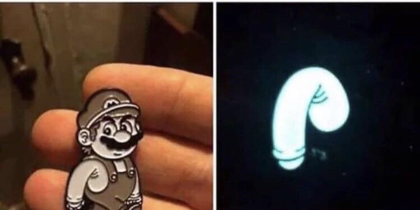 Holding this Super Mario enamel pin under a blacklight