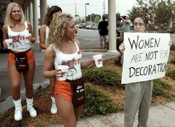 Hooters girls bringing an upset woman something to drink
