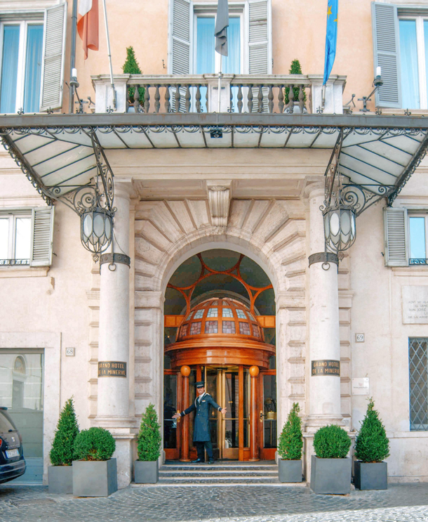I was taking a picture of this hotel in Rome Grand Hotel de la Minerve when this guy asked me to take another one posing this time I hope you see it