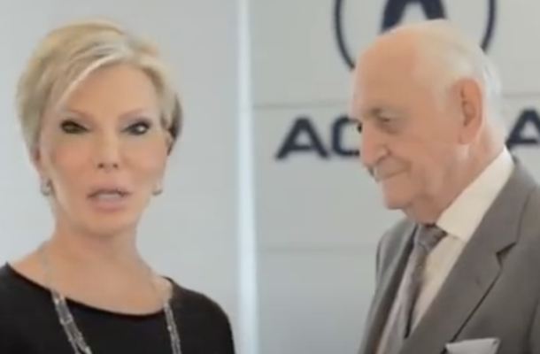 Im pretty sure this car dealers wife is an alien https