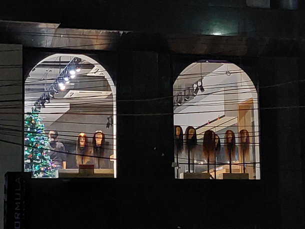 Impaled doll heads as display in front of a hair salon