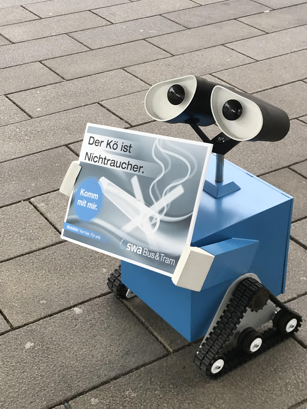 In Augsburg Germany there is this Little guy who drives on its own to remind everybody that Smoking isnt allowed on the Knigplatz Central Tram Station