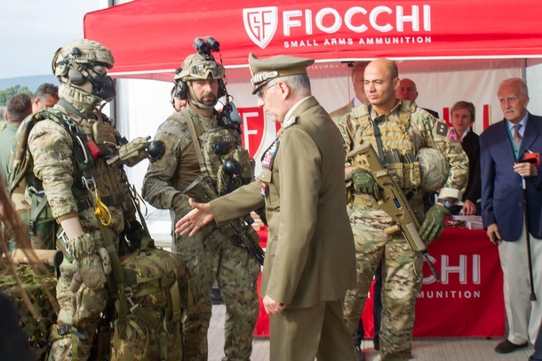 Italian Army General Claudio Graziano trying to shake hands with a military dummy during an official event 