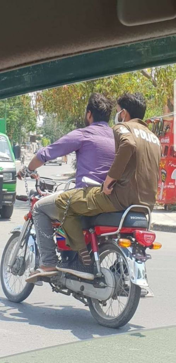Ive never seen a prisoner transport quite like this cuff them and make them drive you to the station on their bike