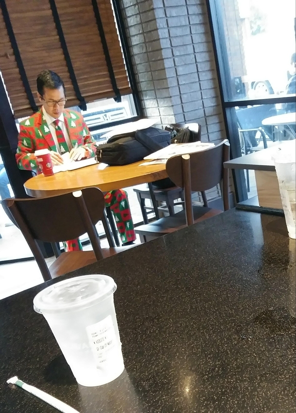 Just a business man in a Christmas suit at a Starbucks