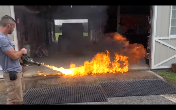 Just a man casually using a flamethrower to kill ants in his barn