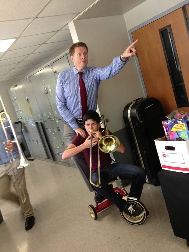 Just me and my professor riding a tricycle while I play the trombone