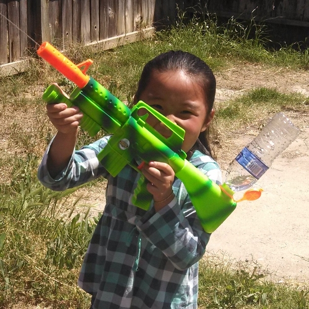 Kid showing off assault rifle with extended magazine