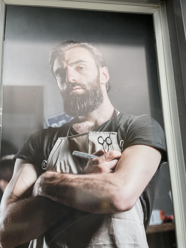 Local barber shop has gigachad as advertisement