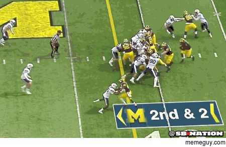 Michigan running back disappears into pile Emerges on other side like its a magic trick