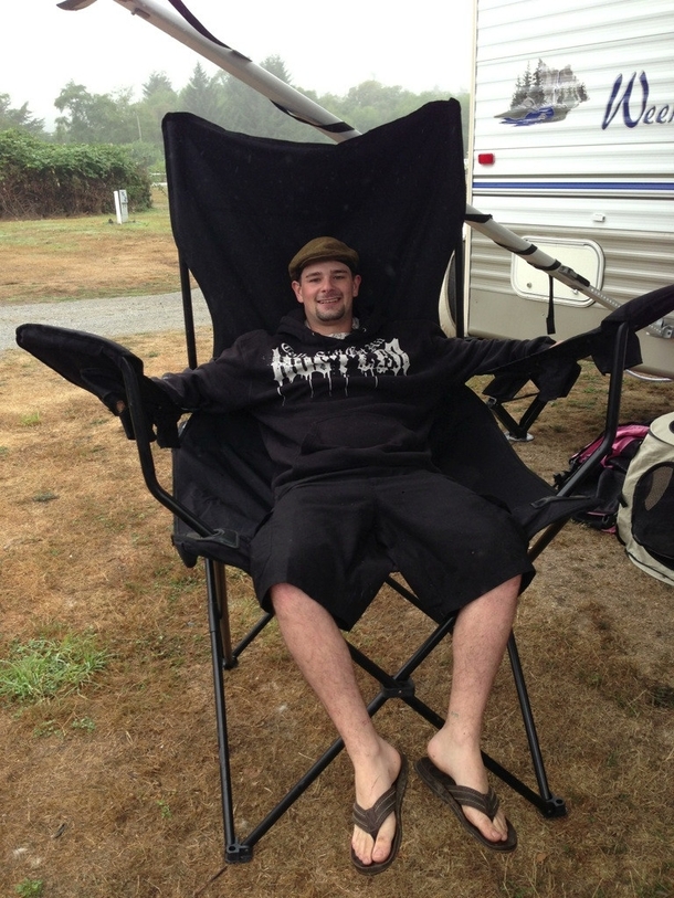 My brother sitting in my new camping chair hes 